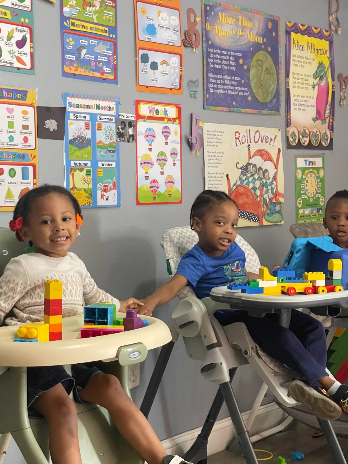 Children smiling and playing with colorful blocks at Shiny Time
