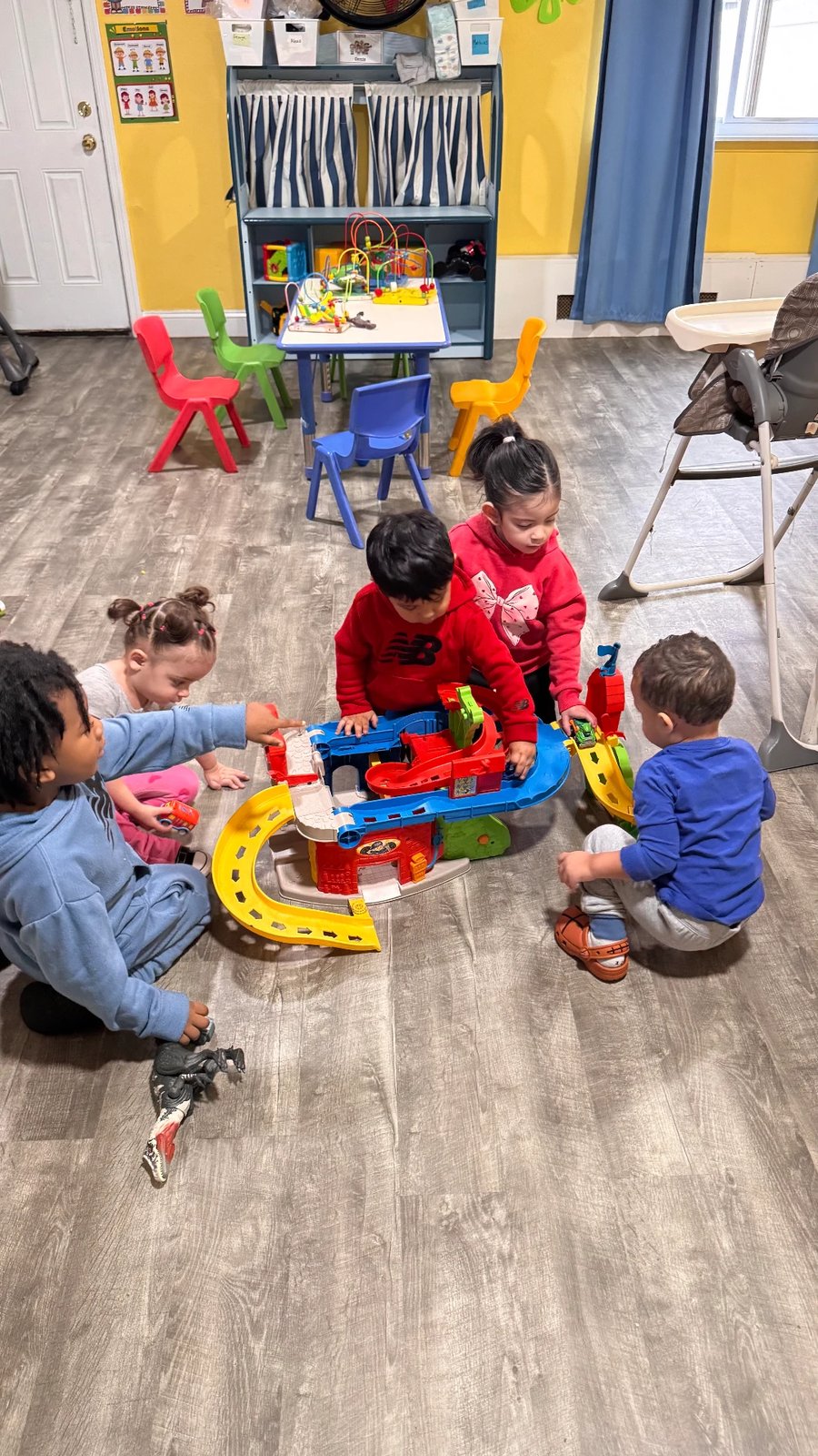 Children playing together in the Shiny Time daycare room