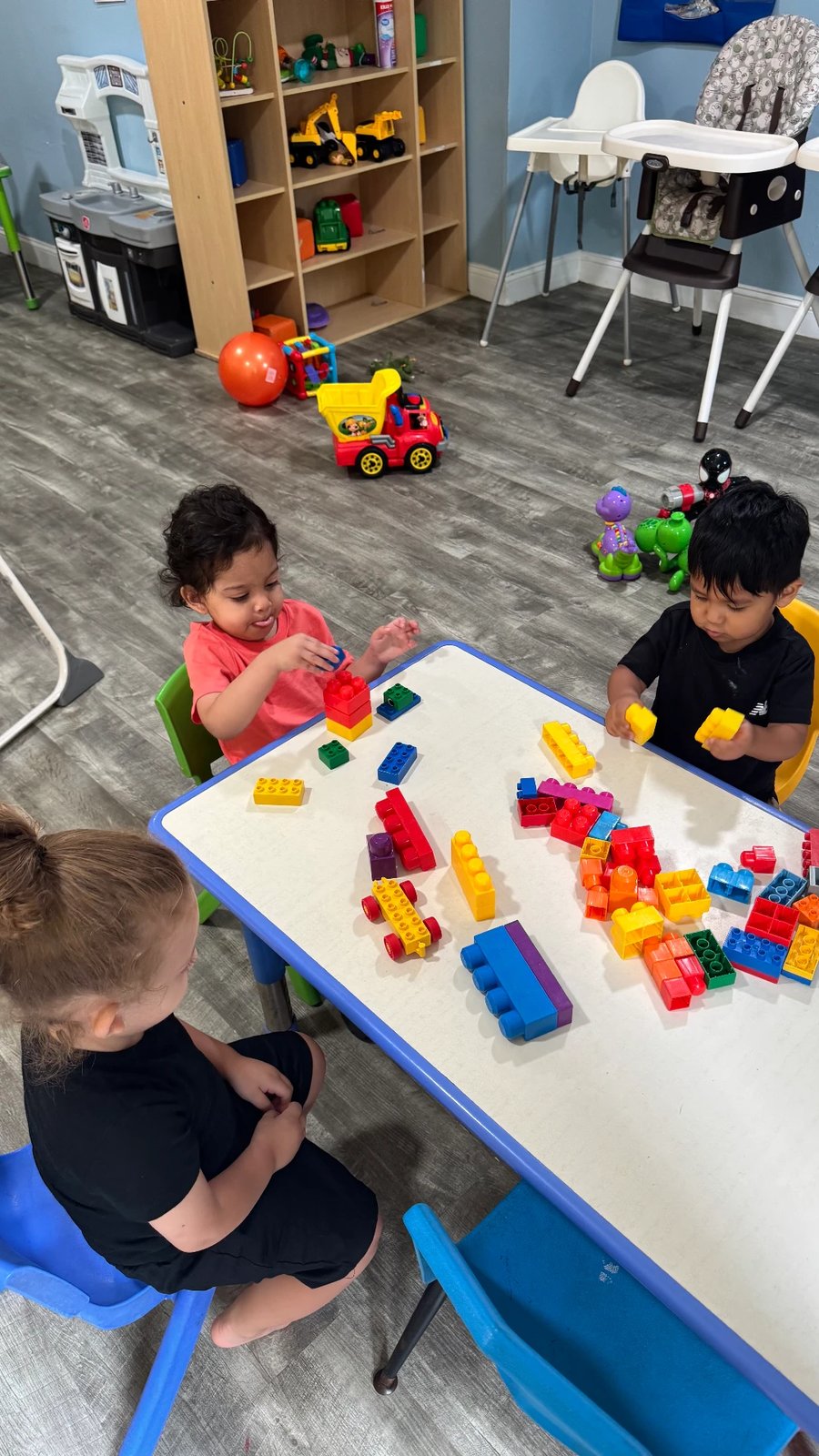 Children building with colorful blocks at the table
