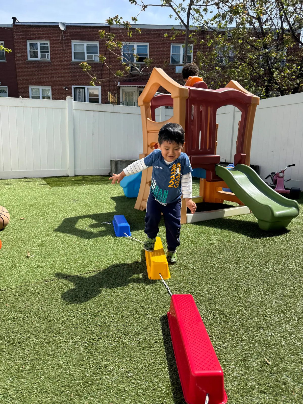 A child climbing on the backyard playground